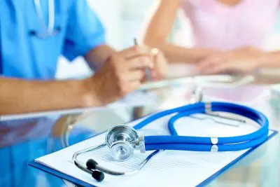 Hands on desk with Stethoscope Small