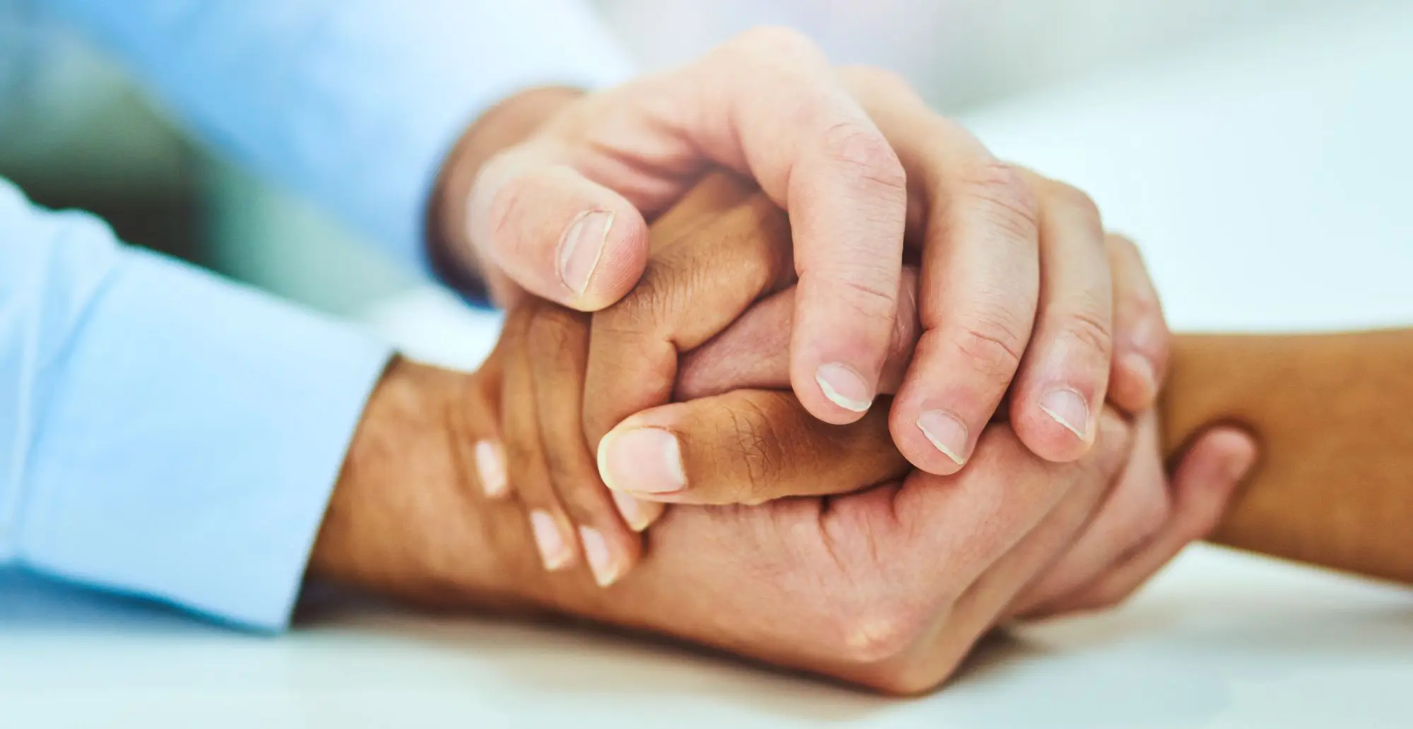 two people holding hands for comfort